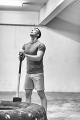 Image showing man workout with hammer and tractor tire