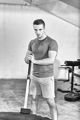 Image showing man workout with hammer and tractor tire