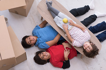 Image showing boys with cardboard boxes around them top view