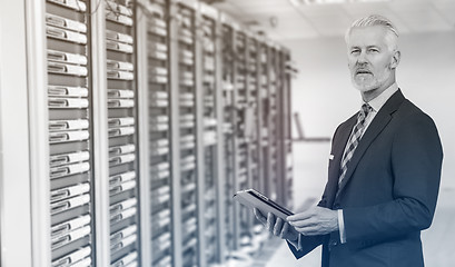 Image showing Senior businessman in server room