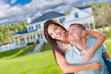 Image showing Playful Young Military Couple Outside A Beautiful New Home.