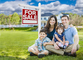 Image showing Young Family With Children In Front of Custom Home and For Sale 