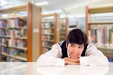 Image showing Young Female Mixed Race Student Daydreaming In Library Looking T