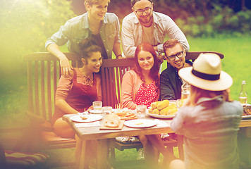 Image showing happy friends having dinner at summer garden party