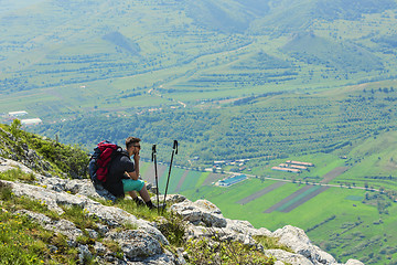 Image showing Hiker Resting on Rocks in Mountains