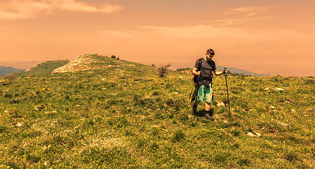 Image showing Man Hiking in Green Mountains