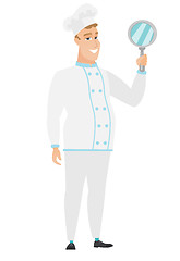 Image showing Caucasian chef cook holding hand mirror.