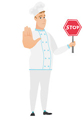 Image showing Caucasian chef cook holding stop road sign.
