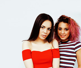 Image showing lifestyle people concept: two pretty stylish modern hipster teen girls having fun together, diverse nation mixed races, happy smiling 