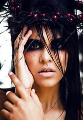 Image showing pretty brunette woman with make up like demon at halloween, clos