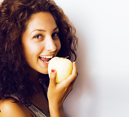 Image showing pretty young real tenage girl eating apple close up smiling