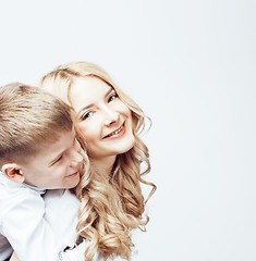 Image showing young modern blond mother with cute son together happy smiling family posing cheerful on white background, lifestyle people concept, sister and brother friends