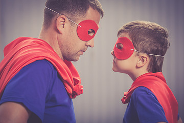 Image showing Father and son playing superhero outdoors at the day time.