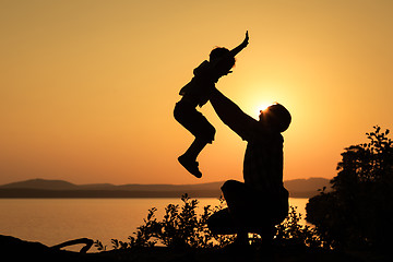 Image showing father and son playing on the coast of lake