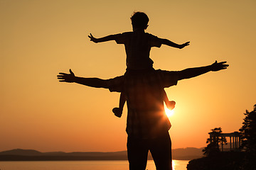 Image showing father and son playing on the coast of lake