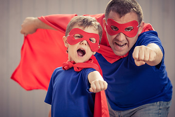 Image showing Father and son playing superhero outdoors at the day time.