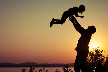 Image showing father and son playing on the coast of lake