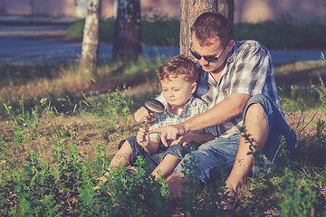 Image showing Father and son playing in the park at the day time.