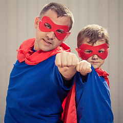 Image showing Father and son playing superhero outdoors at the day time.