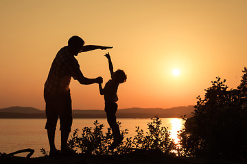 Image showing father and son playing on the coast of lake