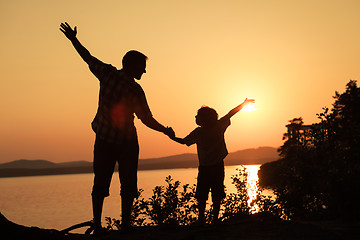 Image showing father and son playing on the coast of lake