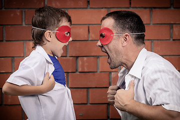 Image showing Father and son playing superhero outdoors at the day time.