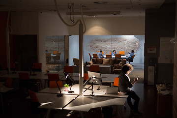 Image showing man working on computer in dark office