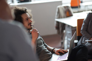 Image showing businessman working using a laptop in startup office