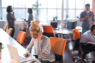 Image showing businesswoman using a laptop in startup office