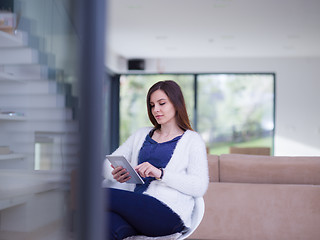 Image showing young women using tablet computer by the window