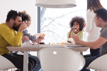 Image showing multiethnic group of happy friends lunch time