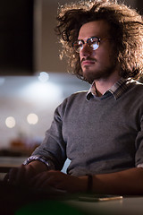 Image showing man working on computer in dark office