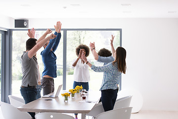 Image showing multiethnic startup Group of young business people celebrating s