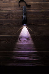 Image showing Included flashlight on wooden texture