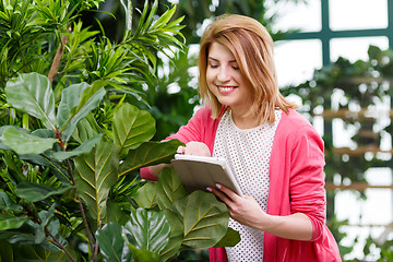 Image showing Young girl at flower shop