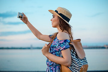 Image showing Young woman and river at city