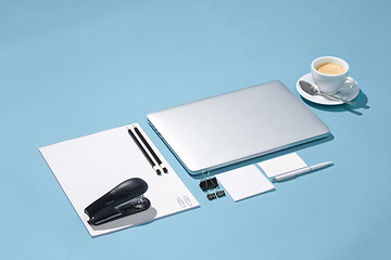 Image showing The laptop, pens, phone, note with blank screen on table