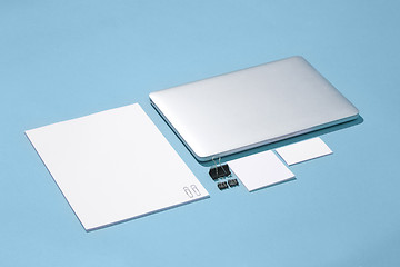 Image showing The laptop, pens, phone, note with blank screen on table