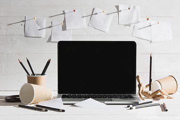 Image showing The front view of notebook and cup of coffee. Inspiration and mock-up concept