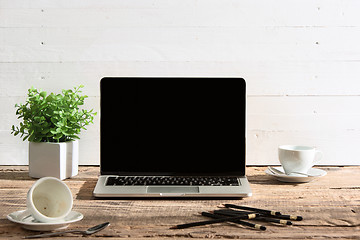 Image showing The front view of notebook and cup of coffee. Inspiration and mock-up concept