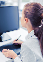 Image showing businesswoman with drawing tablet in office