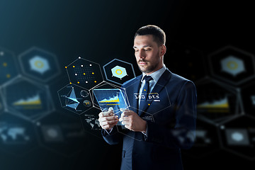 Image showing businessman with tablet pc and virtual projections