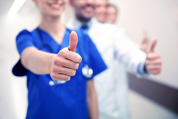 Image showing close up of doctors at hospital showing thumbs