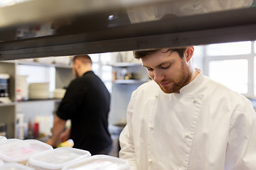 Image showing chef and cook cooking food at restaurant kitchen