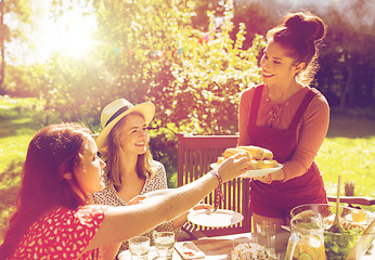 Image showing happy friends having dinner at summer garden party