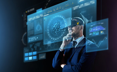 Image showing businessman in virtual reality headset and screens