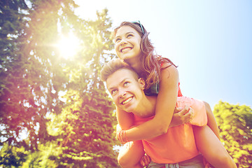 Image showing happy teenage couple having fun at summer park