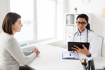 Image showing doctor with tablet pc and woman patient at clinic