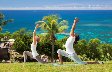 Image showing couple making yoga in low lunge pose outdoors