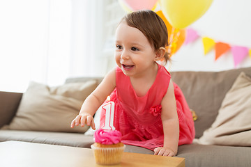 Image showing baby girl with birthday cupcake at home party